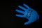 Blown up blue latex surgical glove on black background. Reopening covid safe. Open again text written on medical glove. New normal