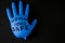 Blown up blue latex surgical glove on black background. Reopening covid safe. Open again text written on medical glove. New normal