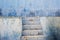Blue abandoned grunge stucco wall and stairs