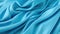 Blue abstract background of silky smooth fabric