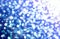 Blue abstract blurred bokeh background white circles glitter