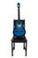 Blue acoustic guitar on a black wooden chair isolated over white background. Trendy musical instrument for playing good music.