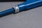 Blue adjustable spanner on grey