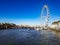 Blue aerial sky sunny day in the city of London ferry wheel London eye next river thames bridge pier ferrys boat clouds