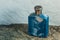 Blue aftershave bottle on wet stone texture