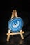 Blue agate slices on a miniature easel dark background