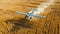 Blue agricultural aircraft plane watering a field during the daytime