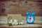 Blue alarm clock, empty paper tag, jasmine branch