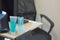 Blue Alcohol gel tube and bottle for Hand wash on desk with office background and copy space