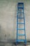 Blue aluminium step ladder that runs across the wall of the house