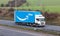 Blue Amazon lorry in motion on the British motorway M1