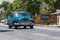 Blue american classic car drive on the road trough VaraderoCuba