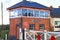 BLUE ANCHOR, SOMERSET, ENGLAND - NOVEMBER 11TH 2012: The signal box and level crossing gates at Blue Anchor station on the West