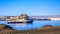 Blue antarctic cruise ship in the lagoon and Gentoo penguins col