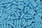 Blue antibiotic capsule pills texture. Pharmaceutical production. Global health. Resistance to antibiotic drugs