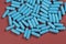 Blue antibiotic capsule pills texture. Pharmaceutical production. Global health. Resistance to antibiotic drugs