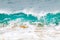 Blue and aquamarine color sea waves and yellow sand  with white foam. Marine beach background.