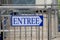 blue arrow indicate sign entree in french text white board panel means entry