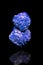 Blue Azurite mineral gemstone in front of black background, rough crystal