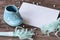 Blue baby shoe and paper trumpets with blanco paper for writing own text.