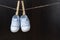 Blue baby sneakers hung with clamps on a string