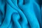 Blue background abstract cloth wavy folds of textile texture