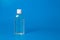 Blue background with a bottle with antibacterial hand gel sanitizer