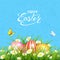 Blue background with butterflies and Easter eggs in grass