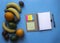 On a blue background notebook on springs notes stickers colored pen lie fruit oranges bananas avocado kiwi