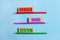 On a blue background, three colored pencils, three wooden blocks with text Domain Name System