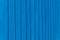 blue background with vertical lines. metal fence