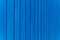 blue background with vertical lines. metal fence
