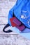 Blue backpack with books, passport, smartphone, tablet and headphones