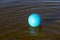 The blue ball is floating in water. A close-up of a volleyball ball. Sports games