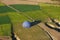 a blue balloon lies deflated on a green field next to the road