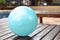 Blue balloon put on the wood bench near the pool, traval for family at hotel
