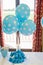 Blue balloons with white dots on some sugar candies with the same color.