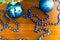 Blue balls on the Christmas tree and garlands on wooden table