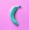 Blue banana on pink background