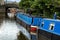 Blue Barges moored to the bank of a Canal in England.