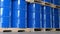 a blue barrel In the warehouse, 200-liter chemical barrels are arranged on wooden pallets and waiting for delivery. Transportation