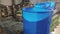 Blue barrels on an automated line in a factory. The process of colorization in the factory