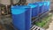 Blue barrels on an automated line in a factory. The process of colorization in the factory