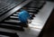 A blue bauble is lying among the synthesizer keys