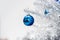 Blue baubles on silver artificial christmas tree