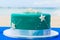 A blue beach themed wedding cake decorated starfish.
