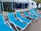 Blue beautiful plastic sunbeds for sunbathing for relaxing in a hotel in a warm tropical oriental country southern resort