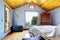 Blue bedroom with wood ceiling and bed interior.