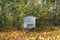 Blue beehive in autumn forest