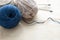 Blue and beige knitting yarn clews on wooden table